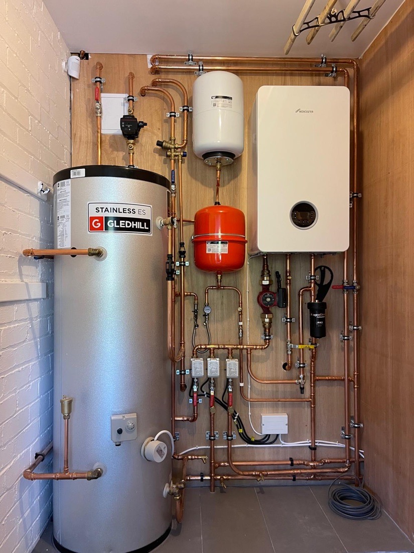 A newly installed Worcester Bosch boiler and Gledhill unvented cylinder with tidy copper pipework