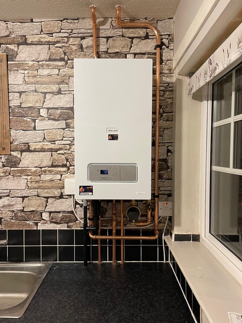 A Glow-worm combi boiler reassembled and safety-checked by a 123-Gas engineer, with tidy copper pipework