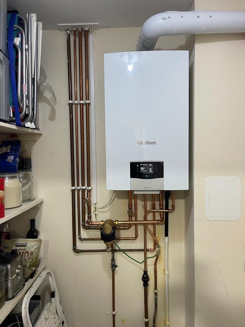 A Vaillant ecoTEC plus boiler serviced by 123-Gas, running normally with its display showing the heating flow temperature